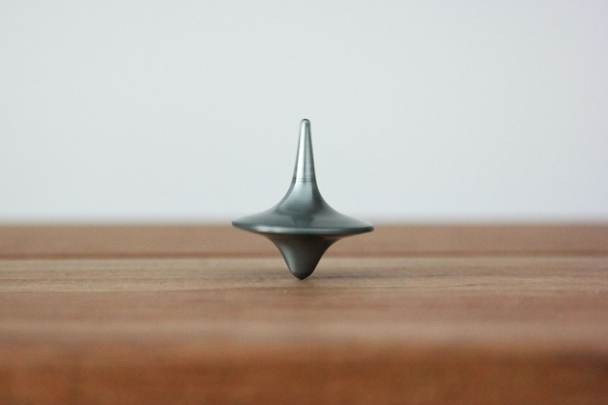  A spinning top on a wooden surface.